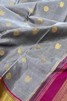 This stunning kanjivaram saree in english grey is handwoven. The bavanji borders have geometrical patterns in magenta pink in gold zari! This exquisite saree is adorned with chakram and peacock motifs in gold zari while the grand pallu with traditional annam motifs in gold zari. Truly a masterpiece! Approximate Length 6.25 - 6.50 mtrs (inclusive of blouse length) Approximate Height - 46 - 52” Saree comes with fall, picot and tassels done when applicable . Blouse piece is cut. Approximate weight Peacock Motifs, Kanjivaram Saree, Kanjivaram Silk Saree, Silk Cotton Sarees, Kanjivaram Sarees, Magenta Pink, Cotton Sarees, Blouse Length, Support Team