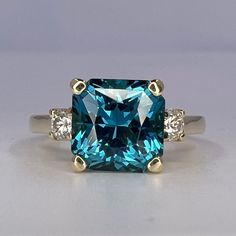 🐕 Big deals! Blue Radiant Cut Engagement Ring With Moissanite Accents in 14K White Gold, London Blue Wedding Ring, Gift For Her #6767 only at $574.00 Hurry. #6767 #SquareStone #GiftForHer #AnniversaryGift #MoissaniteRing #RadiantCut #14kWhiteGold #WeddingRing #EngagementRing #BirthdayGift Square Cut Moissanite Wedding Ring With Center Stone, Gia Certified Square Cut Sapphire Diamond Ring, Fine Jewelry Square Cut Moissanite Rings, Gia Certified Radiant Cut Sapphire Diamond Ring, Gia Certified Blue Topaz Round Cut Ring, Gia Certified Blue Topaz Ring With Round Cut, Blue Diamond Ring With Square Cut, Fine Jewelry Radiant Cut Topaz Ring, Radiant Cut Topaz Ring With Diamond In Prong Setting