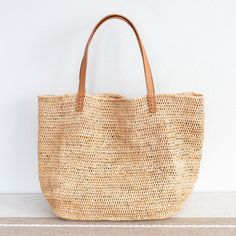 Chic large straw woven tote bag perfect for all occasions. This tote bag is sure to keep up with your busy lifestyle, providing a lightweight and durable design with a classic aesthetic. It’s the perfect way to stay organized while making a stylish statement. Natural Soft Raffia Straw Genuine leather handlesNo linerDimensions: 14"H x 20"W x 8.5"D10" handle drop Designer Style ID: 8583 Large Straw Woven Tote Bag, Summer Bag, Everyday Shoulder Bag, Beach Bag Chic Basket Straw Bag With Rolled Handles, Chic Straw Basket Bag With Rolled Handles, Everyday Summer Bucket Bag With Rolled Handles, Summer Everyday Bucket Bag With Rolled Handles, Chic Natural Bucket Bag With Rolled Handles, Everyday Straw Shoulder Bucket Bag, Everyday Straw Bucket Shoulder Bag, Summer Handwoven Shoulder Bag For Everyday Use, Summer Everyday Bag With Rolled Handles