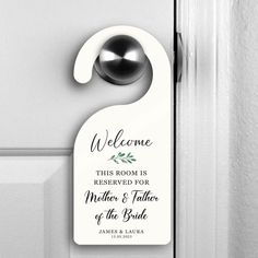 a door hanger with a welcome sign hanging on the side of a white door