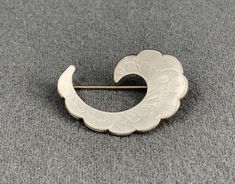 This classic brooch was made by Ivar Holth of Norway, probably in the 1950s. The brooch is sterling silver, and decorated with transparent white enamel using the guilloche technique. The back is marked 925 S Sterling Norway, along with the Ivar Holth maker's mark. This brooch is in excellent condition, and the enameling is intact, with no chips or cracks. Please see photos for details. US buyers only, please. Free shipping. Elegant White Enamel Pin, White Enamel Brooch Jewelry, Antique White Brooch For Formal Occasions, White Retro Brooch For Gift, Antique White Formal Brooch, White Retro Style Brooch For Gift, Retro White Brooches As Gift, White Art Deco Brooches For Formal Occasions, White Retro Brooches As Gift