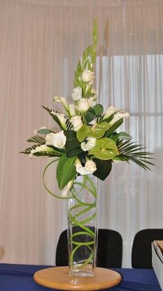 a vase filled with white flowers on top of a table