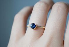 A deep blue Montana Sapphire Engagement Ring set in a rich 18k Gold Bezel ring. Handcrafted in NYC with an Ethically sourced Montana Sapphire. Sapphire Ring Simple, Engagement Rings Simple Round, Round Blue Sapphire Ring, Recycled Gold Ring, Montana Sapphire Engagement, Montana Sapphire Engagement Ring, Sapphire Engagement Ring Set, Montana Sapphire Ring, Pink Sapphire Ring Engagement