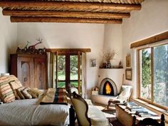 a living room filled with furniture and a fire place in the middle of a room