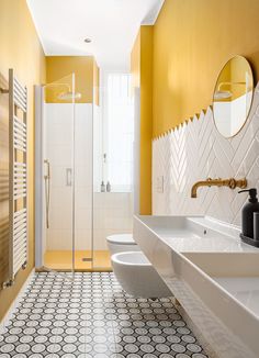 a bathroom with yellow walls and white fixtures