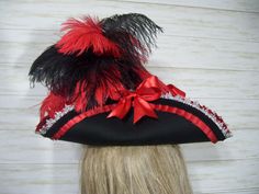 Pirate Style Brimmed Costume Hat For Parties, Black Pirate Hat For Festival, Red Costume Hats And Headpieces For Halloween, Red Costume Hat For Halloween Themed Events, Red Halloween Costume Hat For Themed Events, Pirate Costume Hats And Headpieces For Halloween, Red Hats For Carnival Costume Party, Black Pirate Costume Hat With Curved Brim, Black Pirate Hat For Halloween