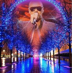 an image of a man with sunglasses on his face and trees in the background at night