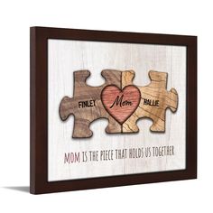 two puzzle pieces with the words family, mom and child on them in brown wood