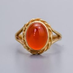 Solid 9K Gold Carnelian Ring A 9K gold ring featuring an oval cabochon carnelian gemstone at its center, exuding a rich and vibrant reddish-orange hue. Surrounding the carnelian gemstone is a twisted gold border, crafted with intricate detail to create a textured and dynamic frame. Vintage piece in good condition, see images for more detail. Size - G+ Stone Dimensions - 8 mm x 10 mm Weight - 3.2g 9ct gold ✅ Domestic and international shipping options available, always sent 'Special Delivery' wit Formal Carnelian Oval Signet Ring, Formal Oval Carnelian Signet Ring, Vintage Oval Carnelian Signet Ring, Yellow Gold Carnelian Oval Cabochon Ring, Carnelian Yellow Gold Rings With Oval Cabochon, Yellow Gold Oval Cabochon Carnelian Rings, Classic Carnelian Cabochon Rings, Heirloom Carnelian Oval Rings, Oval Carnelian Gemstone Signet Ring