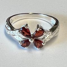 Metal Silver. Gem  Garnet Prong set. 4 stones aprox size .22 - .30 carat each stone. Size measures  7 Vintage 90's never worn. never used in displays. Packed and stored. I am very knowable of stones metals ring sizes etc. I have random pieces i will be selling. New Mint Condition. Not tarnish very shiny just lighting if it looks funny in photos.. All rings come in a box. Garnet Ring Vintage, Garnet Ring Silver, Garnet Engagement Ring, Garnet Rings, Metal Rings, Gemstone Ring, In A Box, Prong Setting, Mint Condition