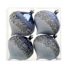 four blue and silver ornaments in a clear box