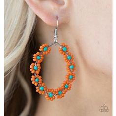 an orange and turquoise beaded hoop earrings on a woman's ear with silver findings