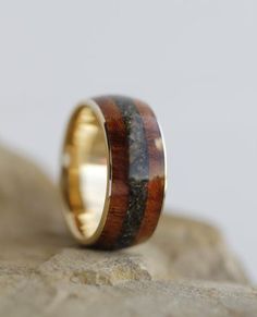 a wooden ring sitting on top of a rock