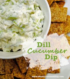 a white bowl filled with cucumber dip surrounded by crackers