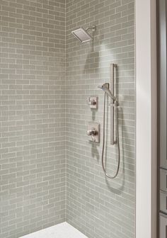 a shower head and hand shower in a bathroom