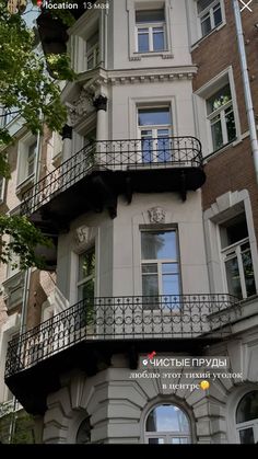 an apartment building with balconies and balcony railings on the top floor is shown