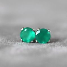 Green Onyx stud earrings. Little emerald green stone earrings. May birthstone Gift. This precious Green Onyx sparkles from the centre of a delicate 14k sterling silver claw setting. These excellent quality, flawless, green onyx gems are a lovely shade of emerald green and will add a splash of colour and fun to your outfits. These little stud earrings have a matching butterfly backs. Alaso available in 14k gold filled or 14k Gold finish. Available stone sizes: 4mm Gemstone shape: brilliant round Green Round Earrings For May Birthstone, Green Earrings For May Birthstone, Green Emerald Round Earrings, Classic Green Earrings For May Birthstone, Green Gemstone Earrings For Anniversary, Green Emerald Earrings For Anniversary, Green Earrings For Anniversary, May Birthstone, Green May Birthstone Earrings For Anniversary, Classic Green Hypoallergenic Jewelry