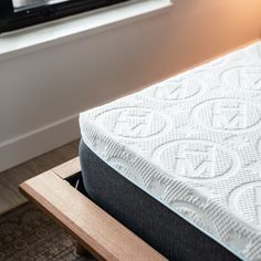 a close up view of a mattress in front of a window