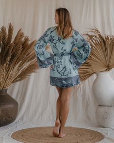 Wrap yourself in the embrace of our Elsa Kimono, a garment that gracefully blends eco-conscious luxury with a serene aesthetic. This exquisite kimono, reversible in nature, offers two tranquil hues – a deep, calming blue and a gentle ice blue, each reflecting a facet of peace and mindfulness. Tailored for a relaxed yet elegant fit, we suggest selecting a size that's 15-20 cm (6-8 inches) larger than your chest circumference, ensuring a comfortable and serene wearing experience. This kimono is mo Chic V-neck Summer Sleepwear, Relaxed Fit Long Sleeve Sleepwear For Summer, Spring Loungewear Tops With Kimono Sleeves, Spring Cotton V-neck Sleepwear, Cotton V-neck Sleepwear For Spring, Summer Tops With Kimono Sleeves For Daywear, Cotton Wrap Sleepwear For Summer, Chic Summer Cotton Sleepwear, Spring Tops With Relaxed Fit And Kimono Sleeves