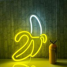 a neon banana sitting next to a fire extinguisher