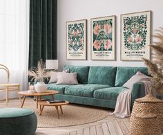 a living room with green velvet couches and art on the wall above them, along with two round coffee tables