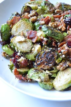 brussel sprouts with bacon and walnuts on a white plate