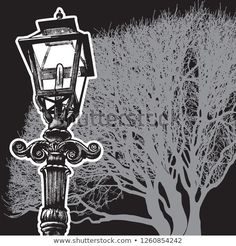 an old fashioned street light in front of a tree