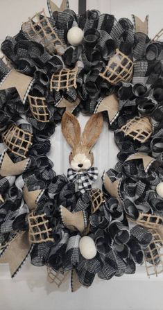 a black and white wreath with a bunny on it