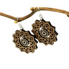 "An intricately cut flower dangles in the center of a mandala to create these boho style earrings. Two tones of wood - walnut and maple - add interest and ensure these earrings will be visible against any hair color. Laser cut wood earrings can be dressed up or down, making them the perfect complement to any outfit! These earrings are strong but so lightweight and comfortable, you will hardly know you have them on! Pair with the matching mandala and flower necklace for a coordinated look: https: Bohemian Flower-shaped Jewelry With Ear Wire, Bohemian Flower-shaped Pierced Earrings, Bohemian Jewelry With Flower-shaped Matching Earrings, Bohemian Jewelry With Matching Flower-shaped Earrings, Bohemian Single Flower Earring, Traditional Flower-shaped Earrings With Ear Wire, Traditional Flower-shaped Jewelry With Ear Wire, Bohemian Adjustable Flower Shaped Earrings, Bohemian Adjustable Flower-shaped Earrings