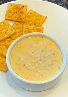 a bowl of soup and crackers on a plate