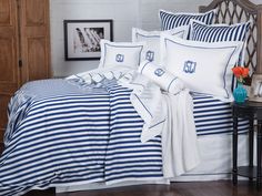 a bed with blue and white striped sheets