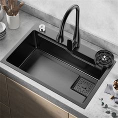 a kitchen sink with a faucet and drainer on the counter next to it