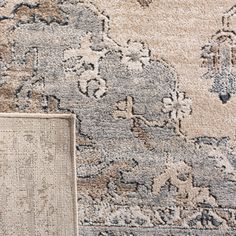 an area rug with various colors and patterns on it, next to a piece of carpet