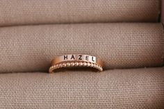 Create your own beautiful set of name rings to show off the people closest to your heart! So simply pretty! Our 3mm high quality 14k Gold-Filled band rings fit one date, name or word in your choice of font. Our rings stack beautifully together, so purchase up to 3 name band rings total for one finger. Please keep the total characters per ring to around 20 max. Up to 3 name ring bands with two spacers will fit on one finger, and we recommend sizing to the next whole size up if you are stacking 3 rings. Please read the sizing details first in the DETAILS section below. D E T A I L S 14k Gold Filled Name Band Rings: Whole US Sizes: 4 - 10 Option to add spacer rings Lowercase tiny script font or UPPERCASE Arial Choose natural or darkened lettering Fit one name, date or word per ring Stamped by Custom Name Stackable Rings In 14k Gold For Anniversary, Custom Name 14k Gold Stackable Rings For Anniversary, 14k Gold Stackable Rings With Custom Name For Anniversary, Personalized Rose Gold Stackable Rings With Round Band, Personalized Rose Gold Stackable Rings, Custom Name Stackable 14k Gold Rings For Wedding, Personalized Rose Gold Stackable Rings For Promise, Custom Name Stackable Rose Gold Promise Rings, Elegant Custom Name Stackable Rings For Promise