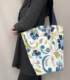 "Weather off shopping, to the beach or grabbing a few books at the library, This shoulder tote bag is perfect for a day out. It is made from royal blue canvas and  floral blue designer fabric and has a snap closure.  Dimensions:  Bag - 12 1/2\" x 13 1/2\"  Shoulder Straps - 2\" x 28 1/2\"  Pocket - 8\" x 7\"" Blue Canvas Tote Beach Bag, Reversible Blue Shoulder Bag For Beach, Blue Canvas Beach Tote Bag, Reversible Blue Shoulder Bag For The Beach, Blue Canvas Beach Bag For Daily Use, Blue Reversible Shoulder Bag For Travel, Casual Blue Canvas Beach Bag, Blue Reversible Tote Shoulder Bag, Reversible Blue Tote Shoulder Bag