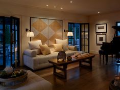 a living room filled with furniture and a piano