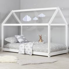 a child's bedroom with a white bed and grey walls