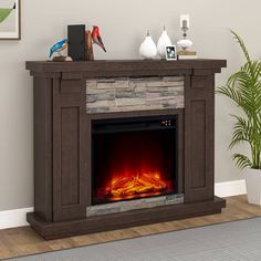 an electric fireplace in a living room next to a potted plant