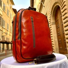 This Italian leather Backpack is a true masterpiece of craftsmanship. Handmade in Florence, Italy, it combines luxurious materials and exquisite attention to detail. Elevate your style and travel in sophistication with this elegant backpack. . Size: Height: 41cm (16.14 inches) Width: 32cm (12.60 inches) Depth: 13cm (5.12 inches) Color: Orange . The story of this backpack: Discover the unparalleled artistry of our Handmade Backpack, a true masterpiece in the realm of Artisanal Italian design. Cra Classic Cognac Backpack For Travel, Classic Cognac Travel Backpack, Luxury Leather-backed Backpack For Daily Use, Luxury Backpack With Leather Backing For Daily Use, Designer Rectangular Backpack For Formal Occasions, Luxury Travel Backpack With Leather Lining, Designer Rectangular Formal Backpack, Designer Formal Rectangular Backpack, Luxury Leather Backpack For Travel In Cognac