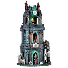 a large clock tower with statues on it's sides and a sign that says the evil behemy