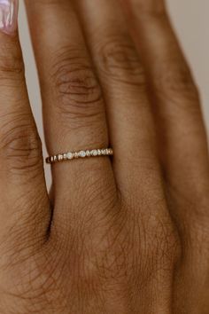 a woman's hand with a diamond ring on it