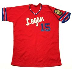 a red soccer jersey with the number 15 on it and two blue stripes around the sleeves