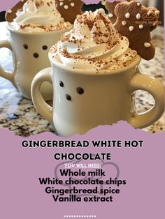 two cups of hot chocolate with whipped cream and gingerbread cookies in the middle, on a marble countertop