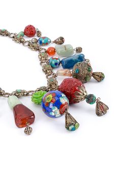 Vintage Chinese Import eclectic bead and cloisonné charm collar necklace. Unique and hard to come by collar necklace featuring painted cloisonné drop beads and stones Silver, agate, coral, jade, orange, scarlet, topaz, quartz Sixteen floral link chain Eleven assortments of seed and bead charm drops with decorative bola ball ends Fold over clasp Silver hardware, acrylic resin Unsigned, made in China Good vintage condition, overall wear, shows signs of wear to beading Measurements Length (End-to-End): 17" Chain Width: 0.47" Largest Charm (Length x Width): 2.5" x 0.98" Weight: 125g Vintage Multicolor Necklace With Spacer Beads, Vintage Multicolor Necklaces With Dangling Beads, Vintage Adjustable Jade Necklace, Vintage Multi-strand Jewelry With Large Beads, Vintage Multi-strand Necklace With Large Beads, Necklace Unique, Drop Beads, Silver Hardware, Watch Necklace