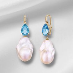 💎 Jewelry Details: *Metal: 14K Solid Gold *Gemstone:    - Type: Topaz    - Cut: Pear-Shaped    - Color: Swiss-Blue    - Clarity: Eye-Clean    - Size: 8 x 12 mm    - Total Carat Weight (CTW): 6.20 *Diamonds:    - Color: G    - Clarity: VS    - Total Carat Weight (CTW): 0.05 *Pearls:   - Type: Cultured Baroque Pearls   - Size: Approximately 15 x 25 mm *Measurements:    - Length: 1 3/4 inch    - Width: 3/4 inch 🪄 Pear-Cut Meaning:  The Pear-Cut is renowned for its timeless elegance and sophistica Pear-shaped Blue Topaz Gemstone Jewelry, Luxury Blue Gemstone Pearl Earrings, Blue Gemstone Luxury Pearl Earrings, Blue Luxury Pearl Earrings With Gemstone, Yellow Gold Teardrop Pearl Earrings With Gemstone, Elegant Teardrop Blue Topaz Earrings, Elegant Blue Topaz Teardrop Earrings, Elegant Blue Topaz Briolette Earrings, Fine Jewelry Pearl Earrings With Pear-shaped Gemstone