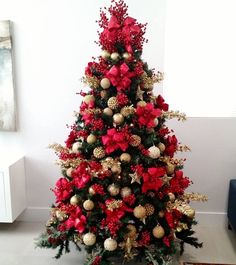 a christmas tree decorated with red and gold ornaments