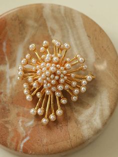 Introducing our Vintage Fashion Pearl Firework Brooches - a charming and stylish accessory, they offer a gorgeous and luxurious look thanks to their unique vintage inspired design. Perfect for both casual and formal attire, these brooches display vintage-inspired fashion and timeless elegance. Metal: 18K Recycled Gold Plated On Brass Gemstone:Imported artificial pearls Dimensions:45*50mm Weight: 26.5g Chic Gold Brooch For Evening, Chic Gold Brooches For Party, Elegant Gold Brooches For Party, Gold Wedding Brooches Chic Style, Gold Wedding Brooches In Chic Style, Chic Gold Wedding Brooch, Gold Chic Wedding Brooches, Chic Gold Wedding Brooches, Unique Gold Brooch For Party