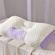 a pillow that is sitting on top of a bed