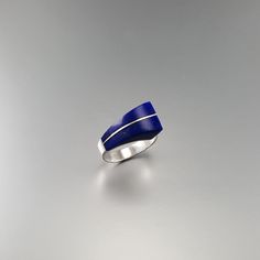 "Modern Lapis Lazuli and Sterling silver statement ring. Unique gift for her, wife, friend, girlfriend, September and December birthstone, 9 year anniversary. This stunning ring is a masterpiece of design and a true eye catcher and puts the center attention on the stone, which is only divided discreetly by a 0.5mm silver line. The natural gemstone shows all its beautiful faces with natural enclosures. This beautiful ring is worked with the technique of inlay, which means the stone is worked seam Modernist Blue Gemstone Jewelry, Modern Silver Jewelry With Birthstone, Blue Fine Jewelry For Gifts, Fine Blue Jewelry For Gifts, Modernist Ring Jewelry For Anniversary, Modern Sterling Silver Rings With Gemstone, Modern Sterling Silver Jewelry With Gemstones, Modernist Gemstone Jewelry For Anniversary, Blue Modernist Jewelry With Polished Finish