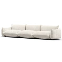 a white couch with four pillows on it